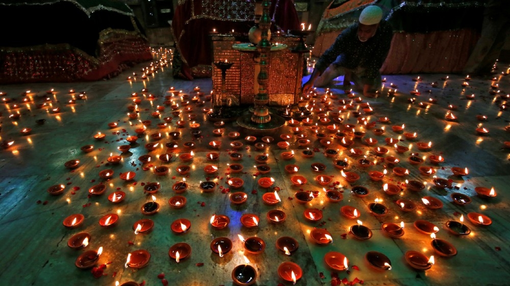 A man lights an oil lamp inside the tomb of Ahmad Shah during a special prayer meeting for the victims of the coronavirus disease (COVID-19), amid the spread of the disease in Ahmedabad,