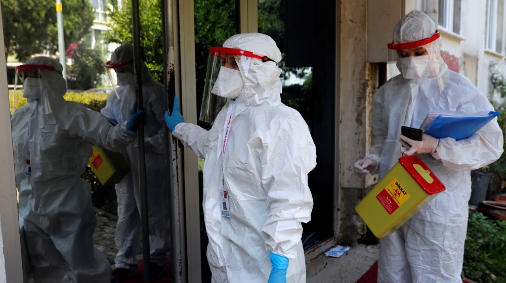 Medical workers of the Bakirkoy District Health Directorate wearing protective suits arrive at a building during an antibody testing program following the coronavirus disease (COVID-19) outbreak, in I