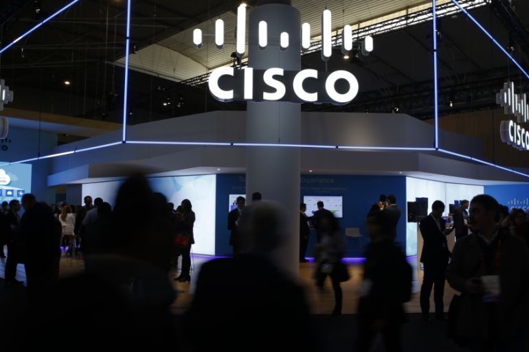 Visitors walk past Cisco''s booth during Mobile World Congress in Barcelona, Spain, February 27, 2017. REUTERS/Paul Hanna
