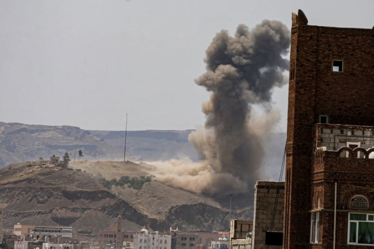Smoke and dust rise from the site of an air strike on the outskirts of Sanaa