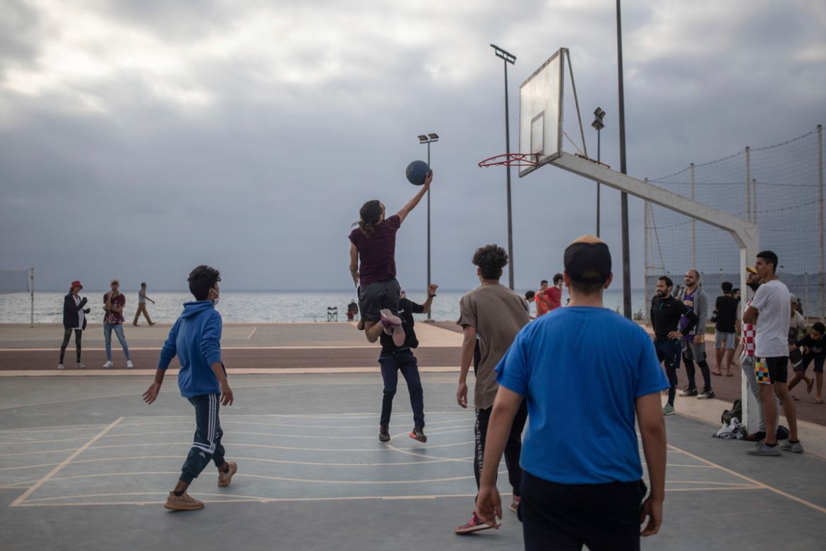 Youths play basketball in a reopened court after lockdown measures were lifted in Rabat, Morocco, Thursday, June 25, 2020. (AP Photo/Mosa''ab Elshamy)