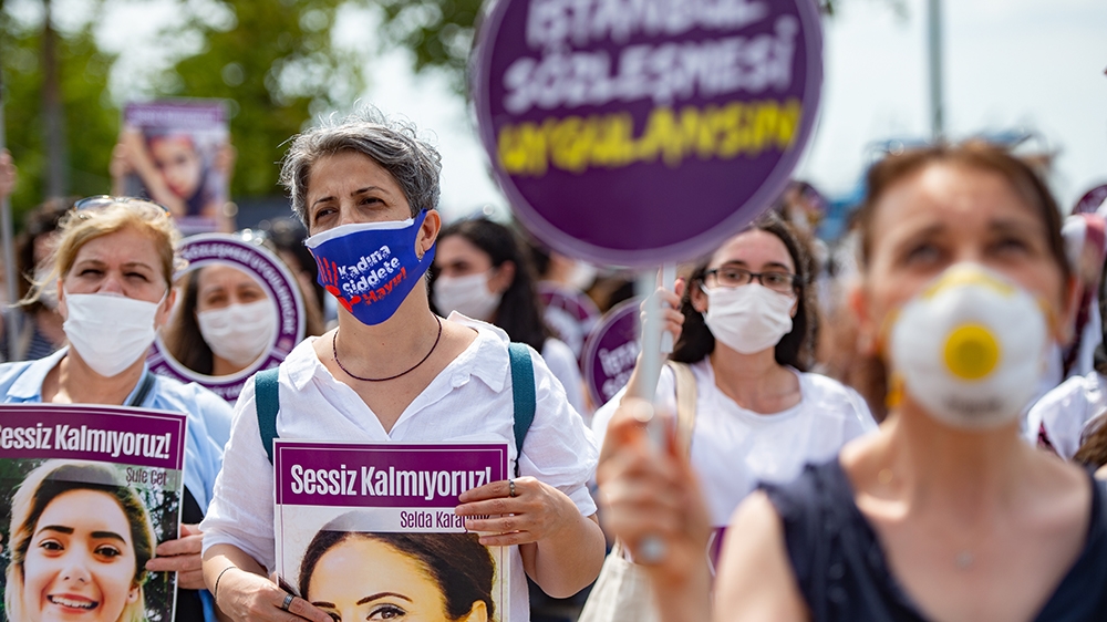 Demonstrators wearing protective face masks, hold portraits of women and placards reading 'we are not quiet', during a protest called by KCDP (We Will Stop Femicides Platform - Kadin Cinayetlerini Dur