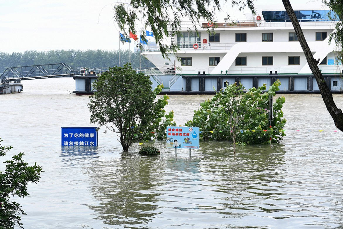 Signs are seen submerged in floodwaters on the bank of the Yangtze River in Nanjing in China''s eastern Jiangsu province on July 12, 2020. - Various parts of China have been hit by continuous downpours