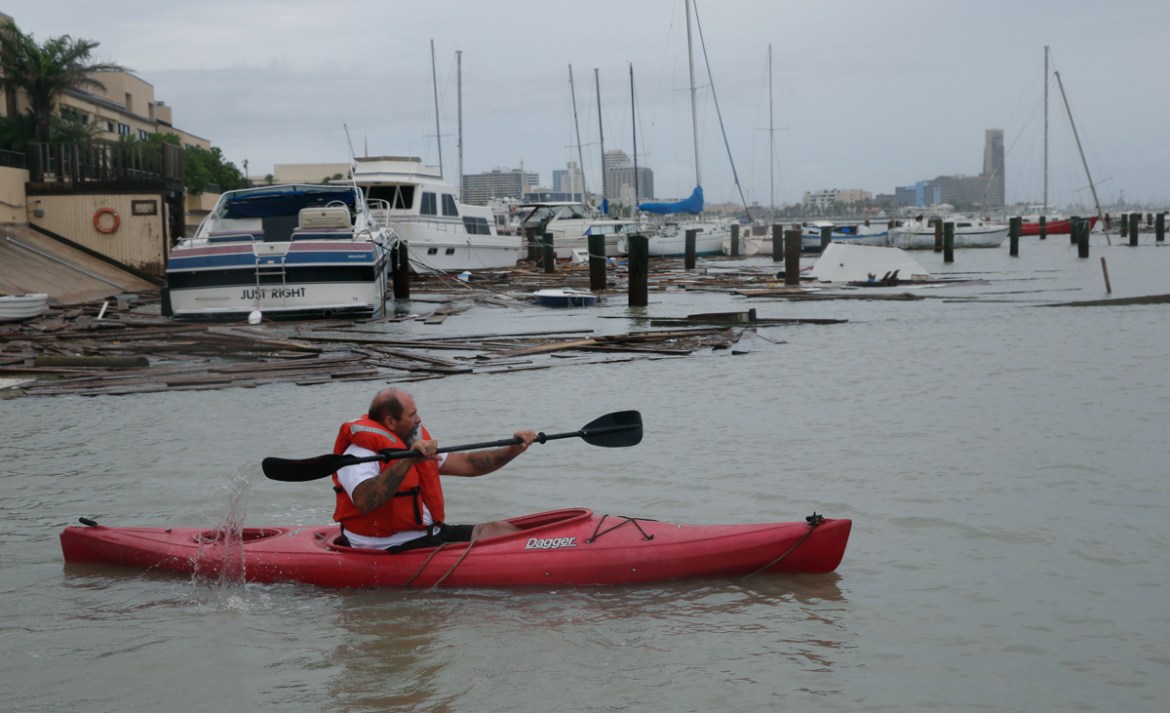 John Nolan uses his kayak to survey the damage to a private marina after it was hit by Hurricane Hanna, Sunday, July 26, 2020, in Corpus Christi,Texas. Nolan''s boat and about 30 others were lost or da