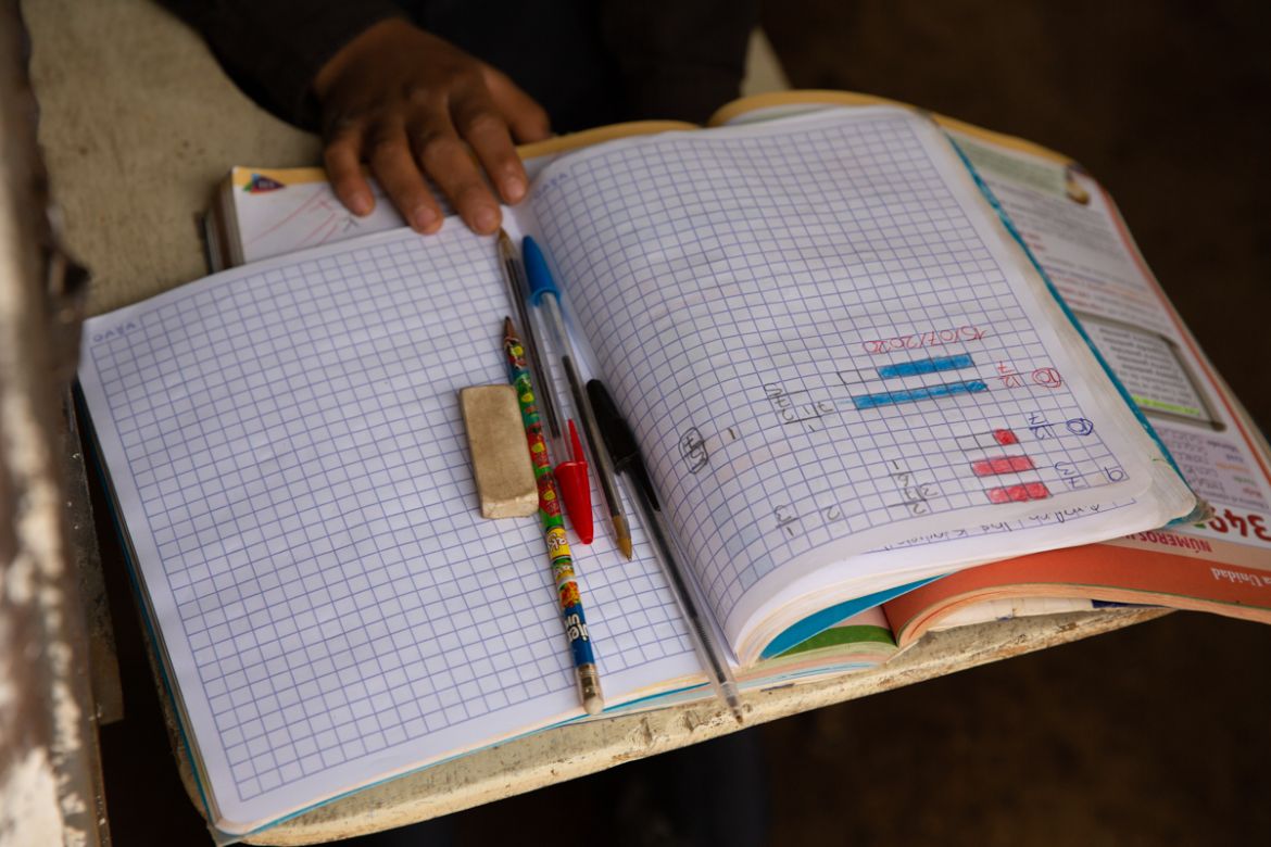 Oscar Rojas, 11, readies his notebooks, pens and pencils, as he prepares for the arrival of his teacher Gerardo Ixcoy, in Santa Cruz del Quiche, Guatemala, Wednesday, July 15, 2020. "I tried to get th