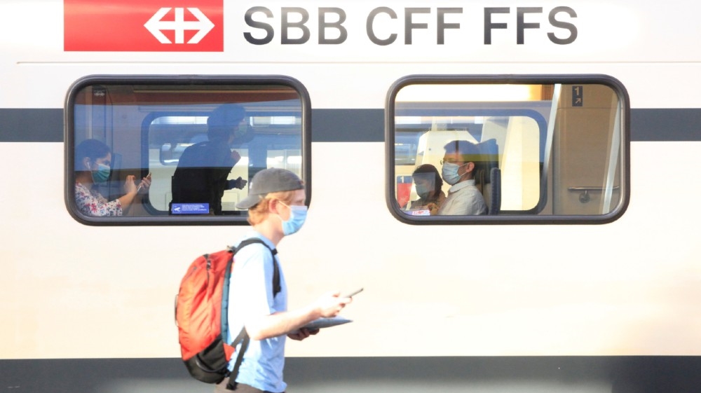 Passengers wear protective masks aboard a train of Swiss railway operator SBB, as the coronavirus disease (COVID-19) outbreak continues, at the Hauptbahnhof central station