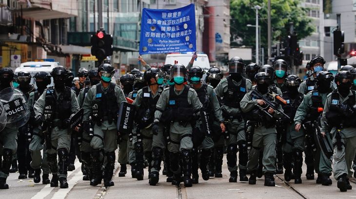 Riot police officers walk as anti-national security law protesters march during the anniversary of Hong Kong''s handover to China from Britain, in Hong Kong, China July 1, 2019. REUTERS/Tyrone Siu