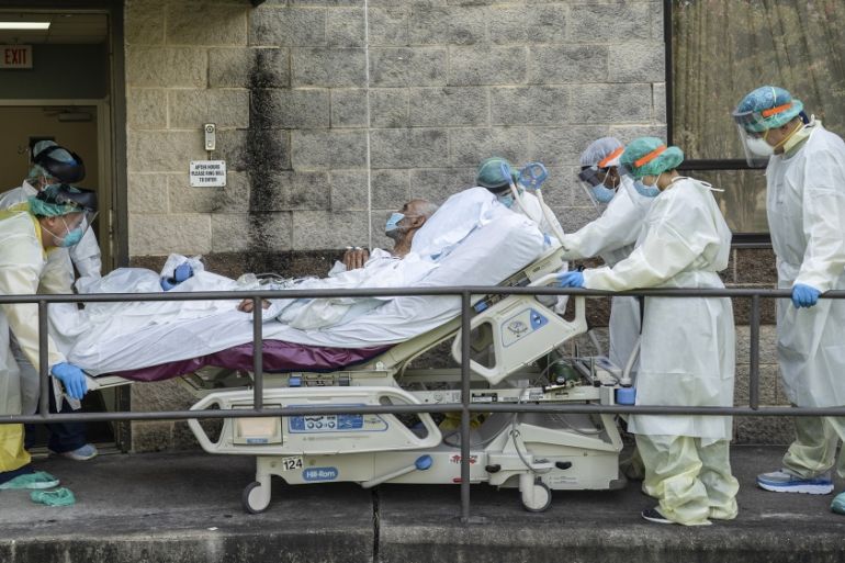 Members of the medical staff move a bed to transfer a patient to another room outside of the COVID-19 intensive care unit at the United Memorial Medical Center on July 2, 2020 in Houston, Texas. COVID