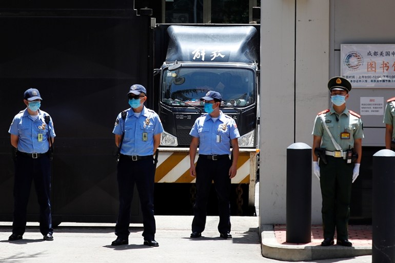 A removal van stands inside the U.S. Consulate General as security personnel guards the front gate in Chengdu, Sichuan province, China, July 26, 2020. REUTERS/Thomas Peter