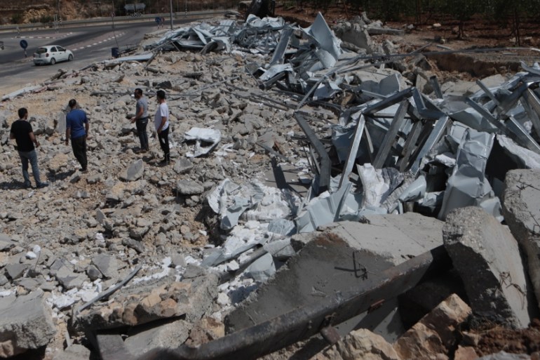 Israeli soldiers demolish an isolation center in Hebron