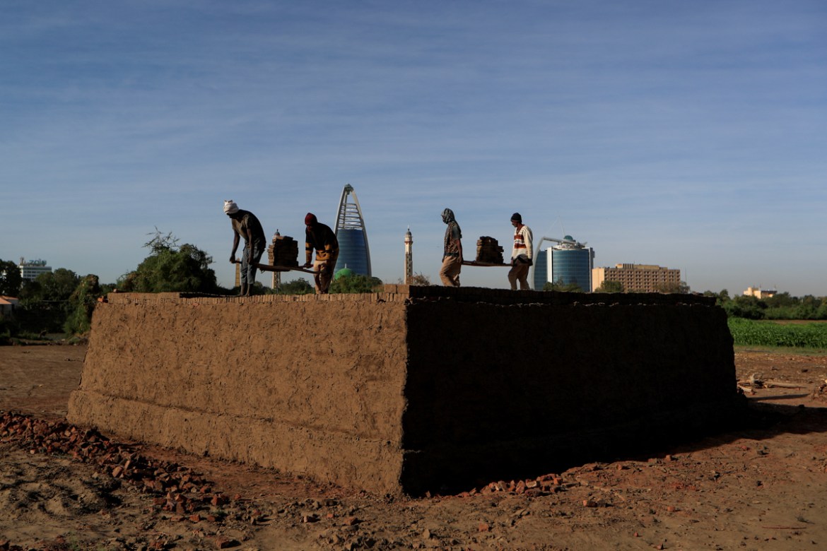 Mohamed Ahmed al Ameen (L), 55, and Mustapha (R), 60, who are both brick makers, prepare bricks to be fired in a kiln at an open-air factory on Tuti Island, Khartoum, Sudan, February 12, 2020. REUTERS