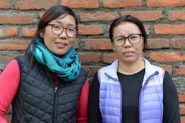 In this picture taken on February 12, 2019 Furdiki Sherpa (R) and Nima Doma Sherpa (L), the Nepali widows of mountaineers, pose for a photo in Kathmandu. - For generations climbing has been firmly the