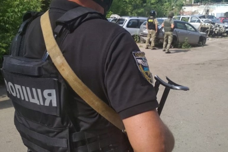 Ukrainian law enforcement officers are seen near a site where a man armed with a grenade holds a policeman hostage in Poltava, Ukraine July 23, 2020. Press Service of the National Police of Ukraine/Ha