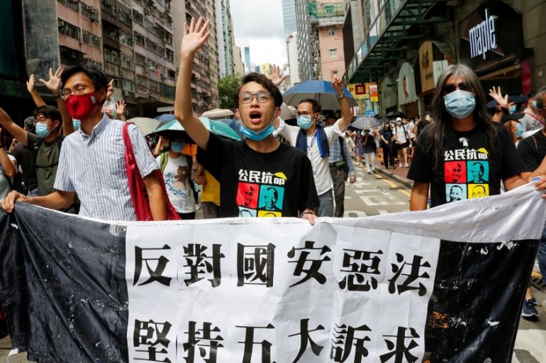 Pan-democratic legislator Eddie Chu Hoi-dick, Vice convener for Hong Kong''s Civil Human Rights Front Figo Chan and activist Leung Kwok-hung march at the anniversary of Hong Kong''s handover to China