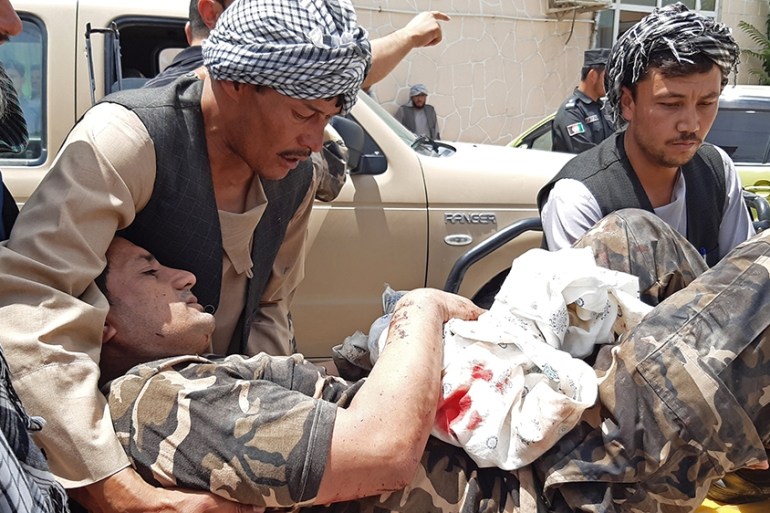 A wounded personnel of National Directorate of Security (NDS) is brought on a stretcher to a hospital after a car bomb exploded in the city of Aybak, in Samangan province on July 13, 2020. - A car bom