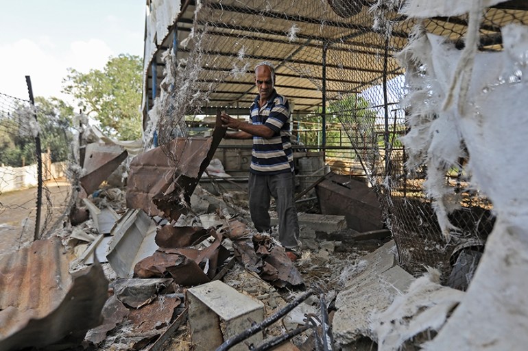 A Palestinian man inspects his damaged farm after an Israeli air strike in Gaza City, on July 6, 2020. - Israeli aircrafts attacked Hamas sites in the Gaza Strip at night on July 5, a Palestinian secu