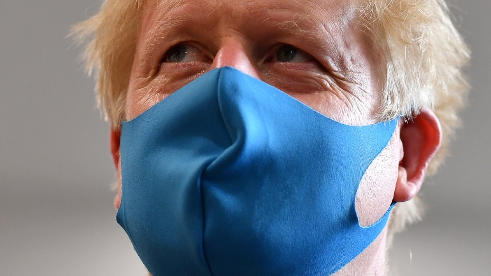 Britain's Prime Minister Boris Johnson, wearing a face mask, visits headquarters of the London Ambulance Service NHS Trust, amid the spread of the coronavirus disease (COVID-19),
