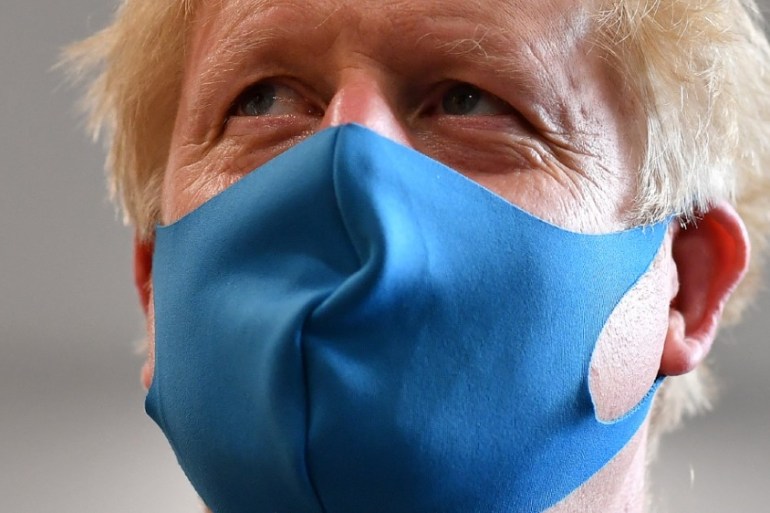 Britain''s Prime Minister Boris Johnson, wearing a face mask, visits headquarters of the London Ambulance Service NHS Trust, amid the spread of the coronavirus disease (COVID-19),