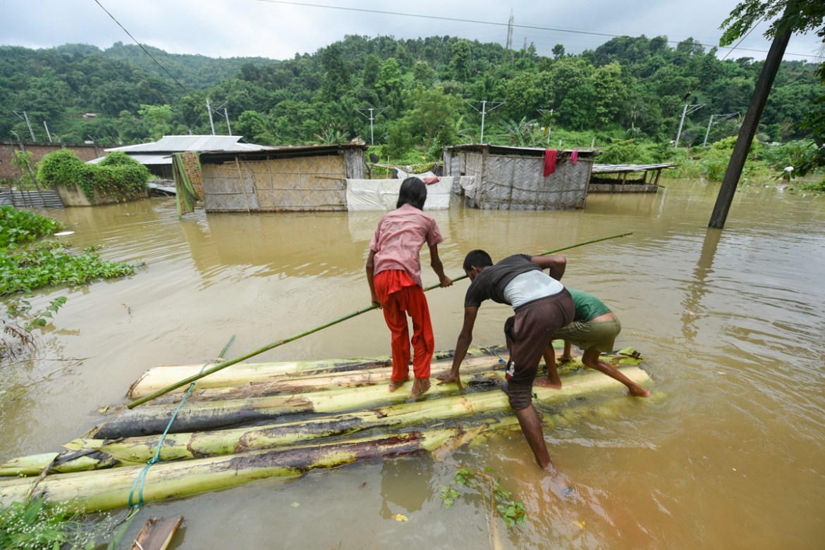Villager uses banana tree raft to move across a flooded locality in Kamrup district of Assam, in India on 14 July 2020. According to reports 3.5 million people effected by floods. (Photo by David Tal