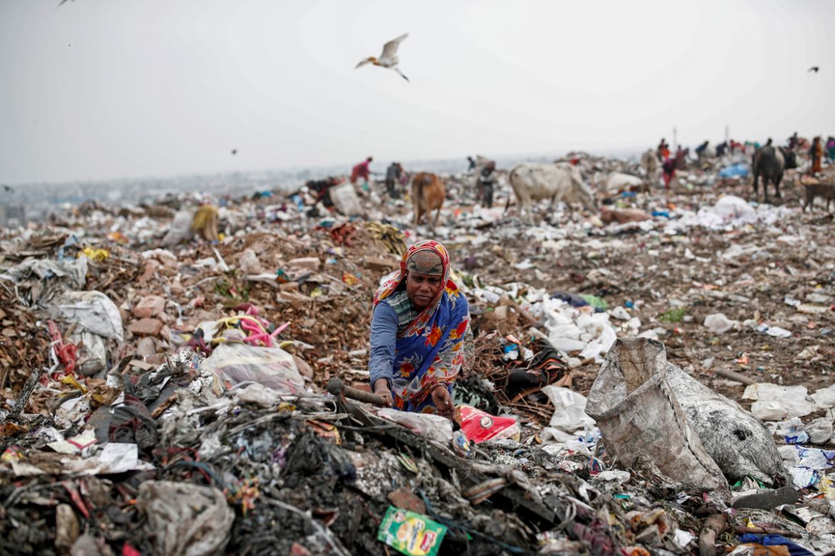 Latifa Bibi, 38, who is married to Mansoor Khan, a waste collector, looks for recyclable materials at a landfill site, during the coronavirus disease (COVID-19) outbreak, in New Delhi, India, July 16,