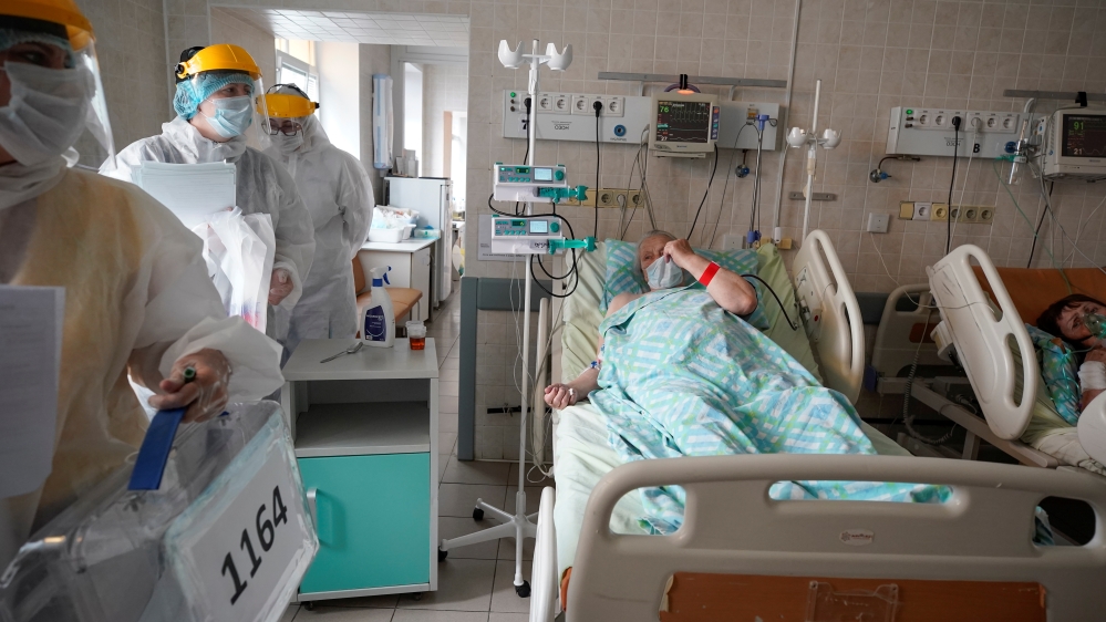 Members of an electoral commission visit a regional hospital during a nationwide vote on constitutional reforms in Tver