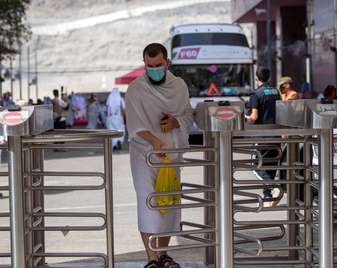 A Muslim pilgrim wearing a protective mask is seen as he heads to Arafat during the annual Haj pilgrimage amid the coronavirus disease (COVID-19) pandemic, in Mina, Saudi Arabia July 30, 2020. Saudi P