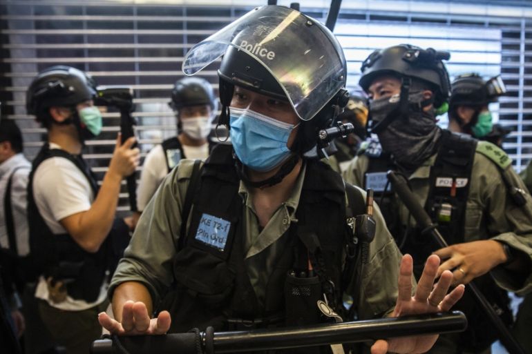 Riot police clear an area during a demonstration in a mall in Hong Kong on July 6, 2020, in response to a new national security law introduced in the city which makes political views, slogans and sign
