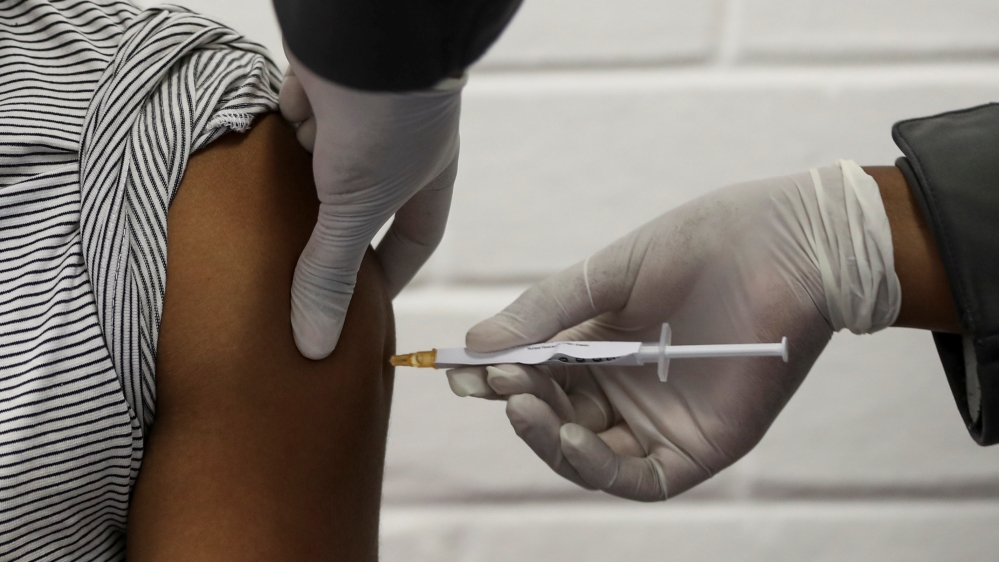 A volunteer receives an injection from a medical worker during the country''s first human clinical trial for a potential vaccine against the novel coronavirus, in Soweto