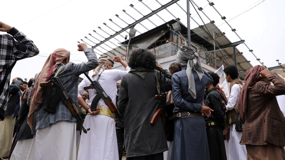 Armed Houthis gather outside the United Nations offices to denounce the Saudi-led coalition's blockade, in Sanaa