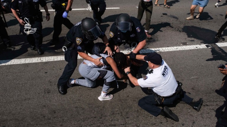Black Lives Matter protesters are arrested by NYPD officers on the Brooklyn Bridge, Wednesday, July 15, 2020, in New York. Several New York City police officers were attacked and injured Wednesday on