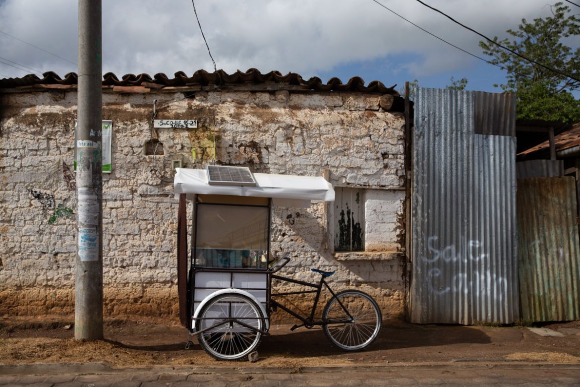Teacher Gerardo Ixcoy sits parked just outside the doorway of a student''s home, inside his secondhand adult tricycle he converted into a mobile classroom, in Santa Cruz del Quiche, Guatemala, Wednesda