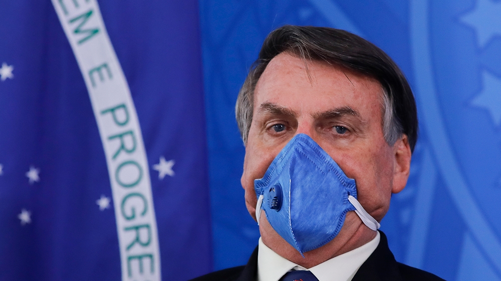 Brazil President Jair Bolsonaro wears a face mask during a press conference on the coronavirus pandemic COVID-19 at the Planalto Palace in Brasilia, Brazil on March 20, 2020. - Brazil's government
