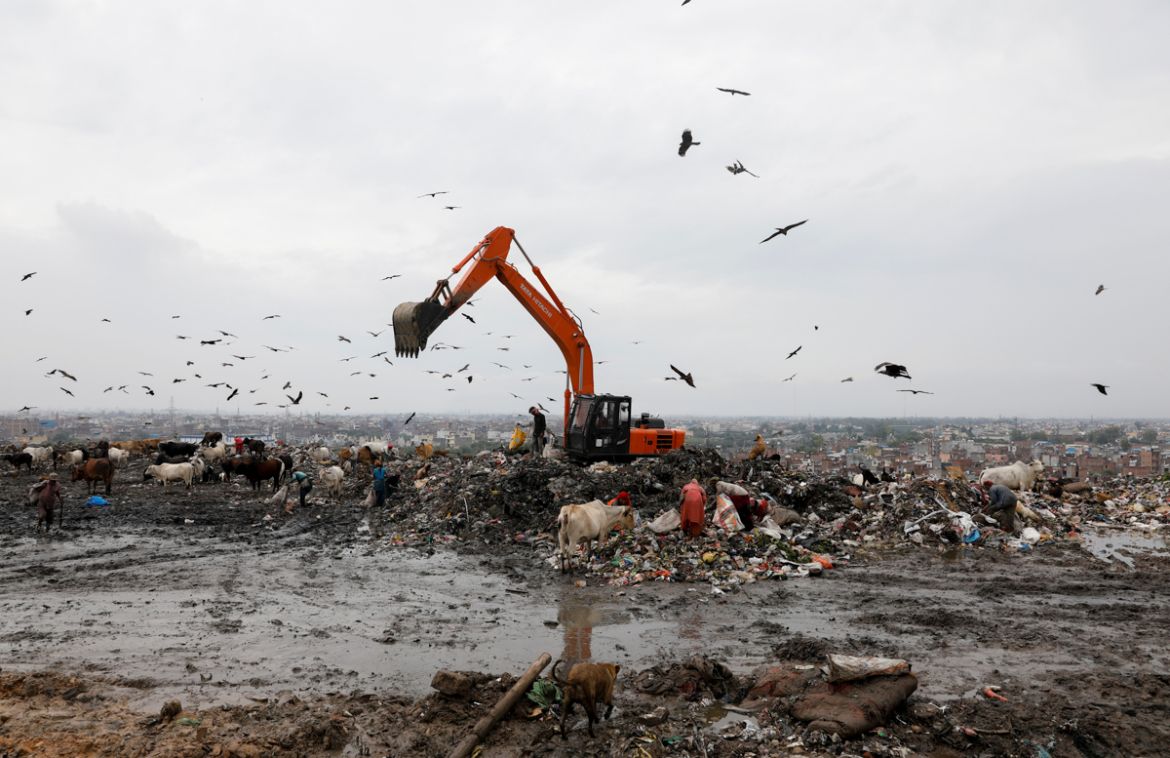 Waste collectors look for recyclable materials at a landfill site, during the coronavirus disease (COVID-19) outbreak, in New Delhi, India, July 22, 2020. REUTERS/Adnan Abidi SEARCH "COVID-19 MEDI
