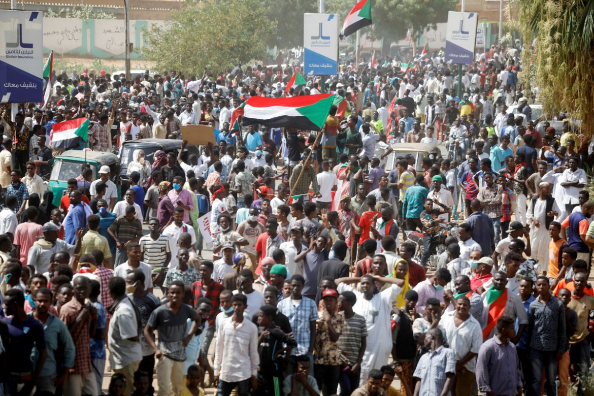 Civilians gather as members of Sudanese pro-democracy protest on the anniversary of a major anti-military protest, as groups loyal to toppled leader Omar al-Bashir plan rival demonstrations in Khartou