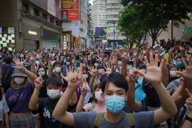 Protesters against the new national security law gesture with five fingers, signifying the "Five demands - not one less" on the anniversary of Hong Kong''s handover to China from Britain in Hong Kong,
