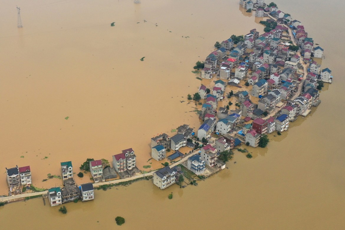 This aerial view shows submerged streets and inundated buildings after a dam was breached due to flooding in Jiujiang in China''s central Jiangxi province on July 13, 2020. - Floods across central and