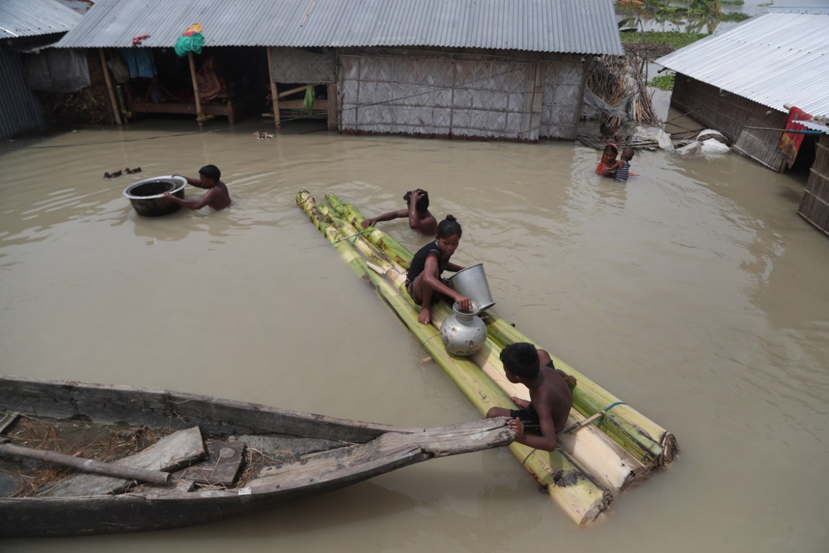 Flood affected villagers are seen near their partially submerged houses in Gagolmari village, Morigaon district, Assam, India, Tuesday, July 14, 2020. Hundreds of thousands of people have been affecte
