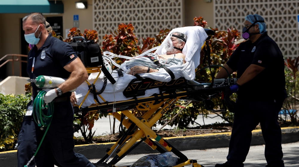 Emergency Medical Technicians (EMT) leave with a patient at Hialeah Hospital where the coronavirus disease (COVID-19) patients are treated, in Hialeah, Florida, U.S., July 29, 2020. REUTERS/Marco Bell