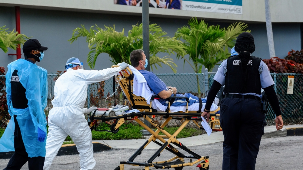 Emergency Medical Technicians (EMT) arrive with a correctional patient at North Shore Medical Center where the coronavirus disease (COVID-19) patients are treated, in Miami, Florida, U.S. July 14, 202