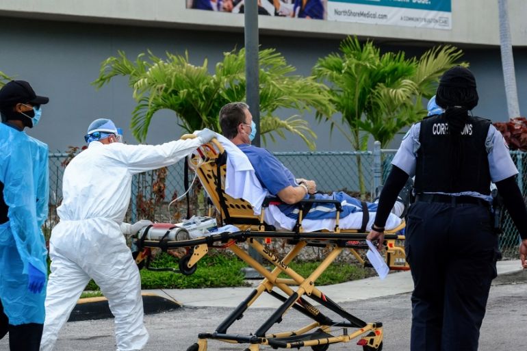 Emergency Medical Technicians (EMT) arrive with a correctional patient at North Shore Medical Center where the coronavirus disease (COVID-19) patients are treated, in Miami, Florida, U.S. July 14, 202