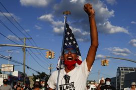 A protester leads a chant down a main thoroughfare during a Black Lives Matter march through a residential neighborhood calling for racial justice, Monday, July 13, 2020, in Valley Stream, N.Y. (AP Ph