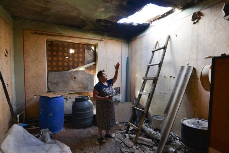 A local woman shows damage in her house after the shelling by the Azerbaijan side in the Aygepar village in Armenia''s Tavush region, Armenia, Wednesday, July 15, 2020. Three days of fighting between A