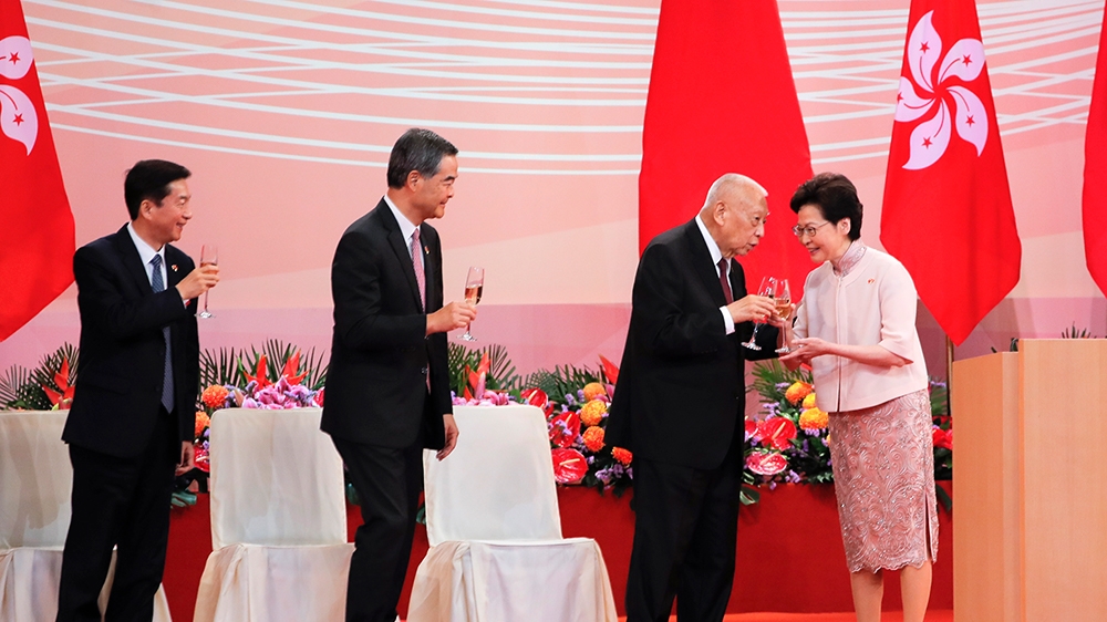 Hong Kong's Chief Executive Carrie Lam, right, make a toast to former Hong Kong Chief Executive Tung Chee-hwa, as former Hong Kong Chief Executive Leung Chun-ying, second from left, and China's liaiso