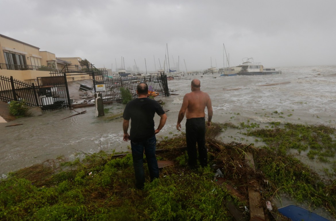 Boat owners examine the damage after the docks at the marina where their boats had been secured were destroyed as Hurricane Hanna made landfall, Saturday, July 25, 2020, in Corpus Christi, Texas. (AP