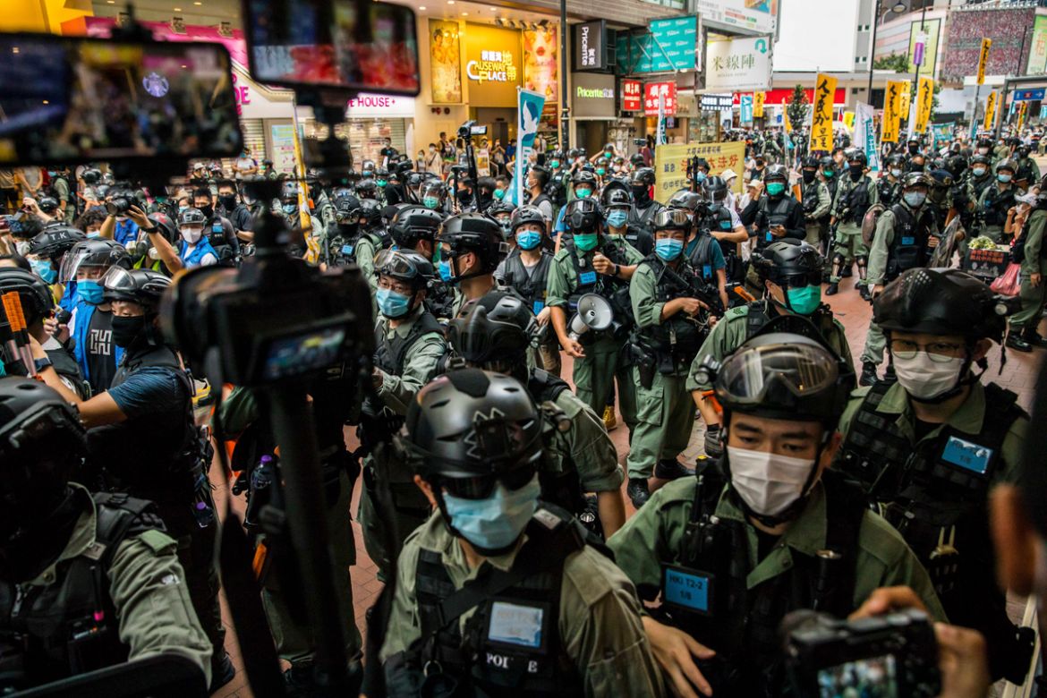Riot police clear a street as protesters gathered to rally against a new national security law in Hong Kong on July 1, 2020, on the 23rd anniversary of the city''s handover from Britain to China. - A m