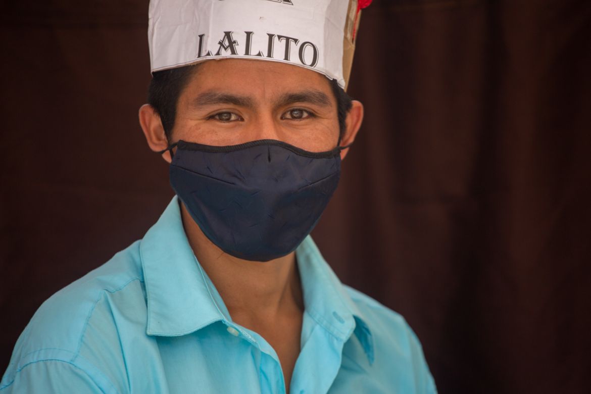 Teacher Gerardo Ixcoy, wearing a protective face mask, found a way to give individual instruction to his sixth-grade students amid the new coronavirus pandemic, in Santa Cruz del Quiche, Guatemala, We
