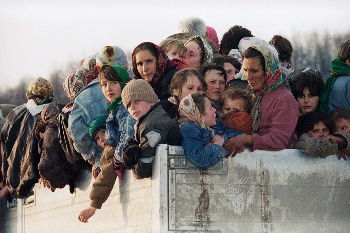 FILE In this Monday March 29, 1993 file photo evacuees from the besieged Muslim enclave of Srebrenica, packed on a truck en route to Tuzla, pass through Tojsici, 56 miles north of Sarajevo. More than
