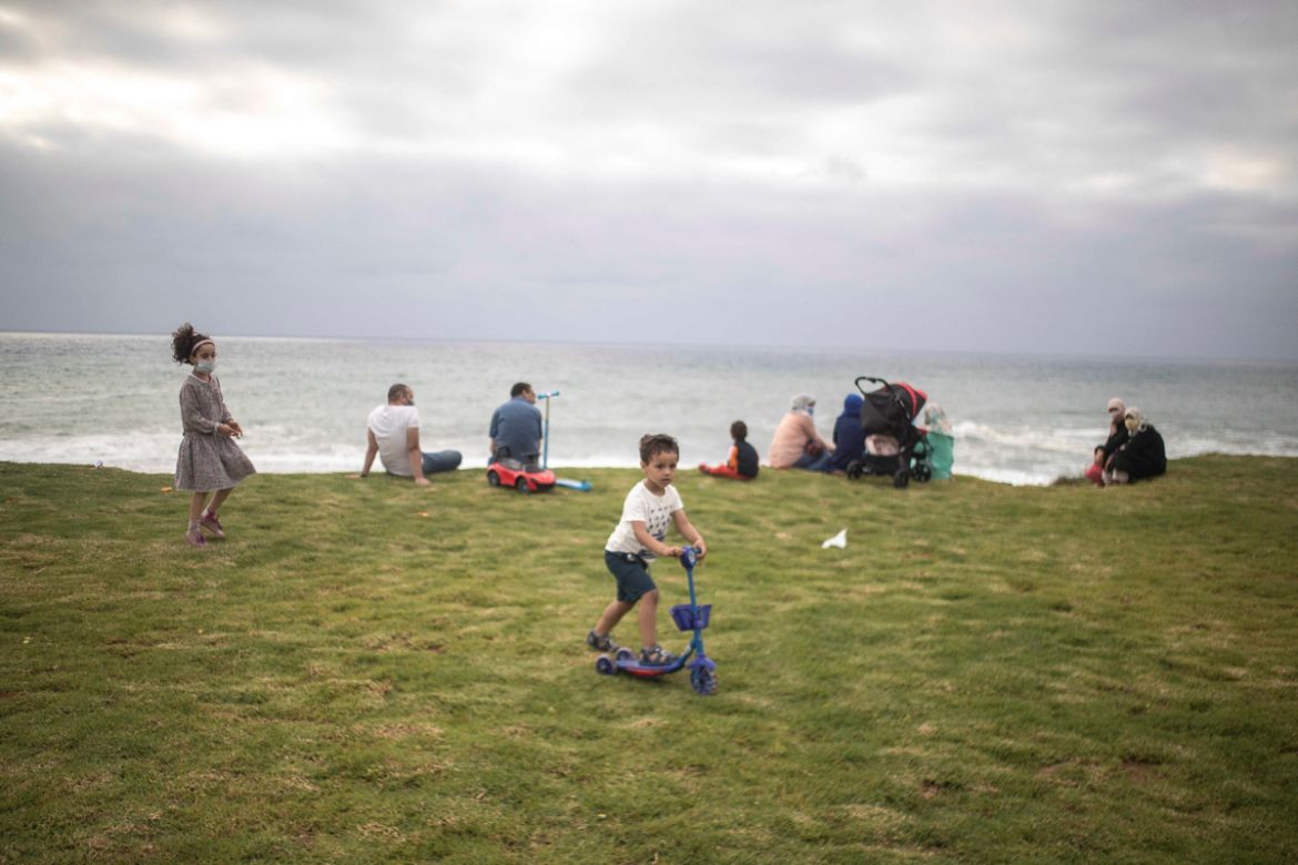 Families gather at a beach after lockdown measures were lifted in Rabat, Morocco, Thursday, June 25, 2020. Moroccans are re-experiencing a taste of the life before. In newly opened public spaces, ever