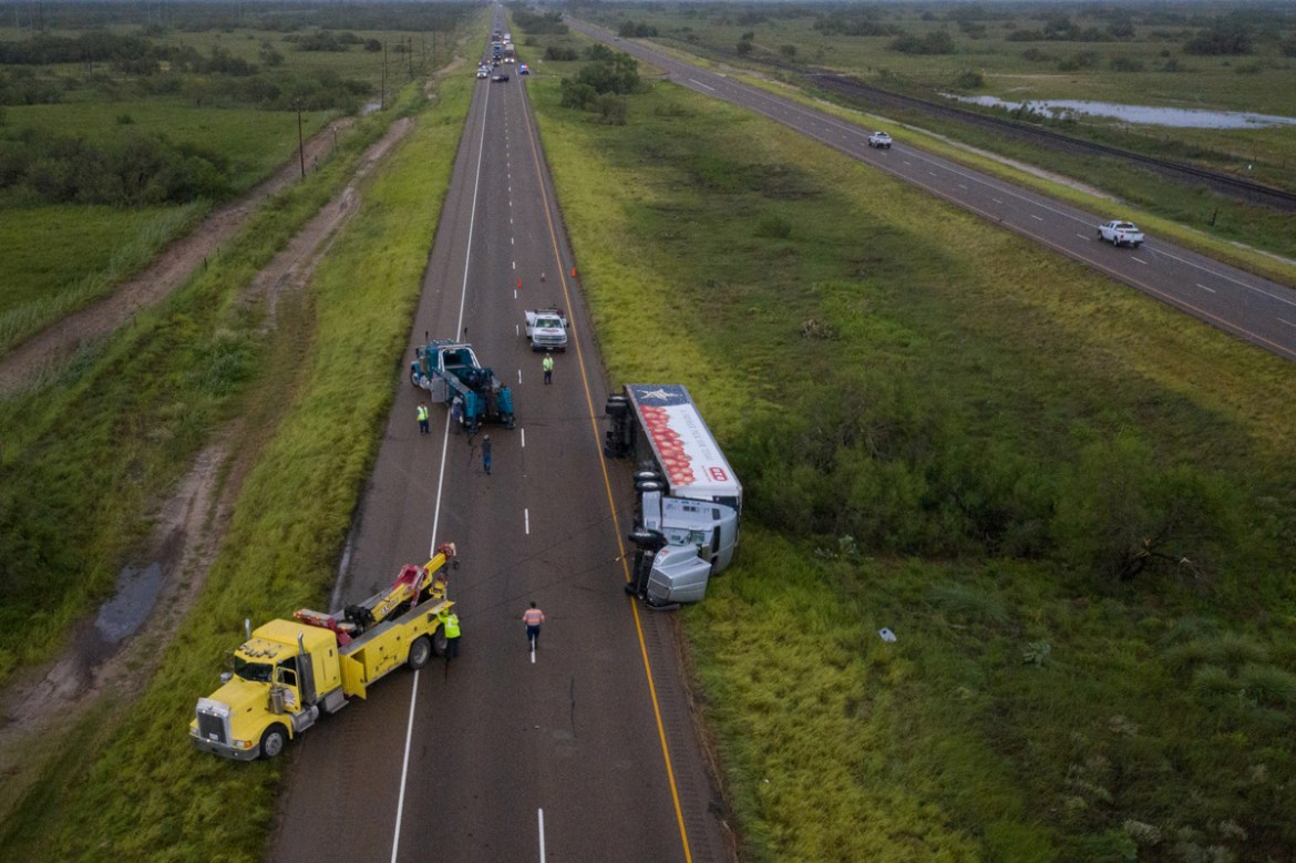 Traffic is halted as tow trucks surround an overturned HEB supermarket truck along US Route 77 in the aftermath of high wind gusts from Hurricane Hanna in Sarita, Texas, U.S., July 26, 2020. No fatali