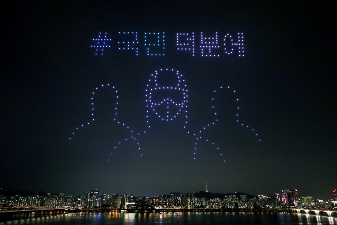 Drones fly over the Han river showing messages to support the country as a measure to avoid the spread of the coronavirus disease (COVID-19) continues in Seoul, South Korea, July 4, 2020. Picture take